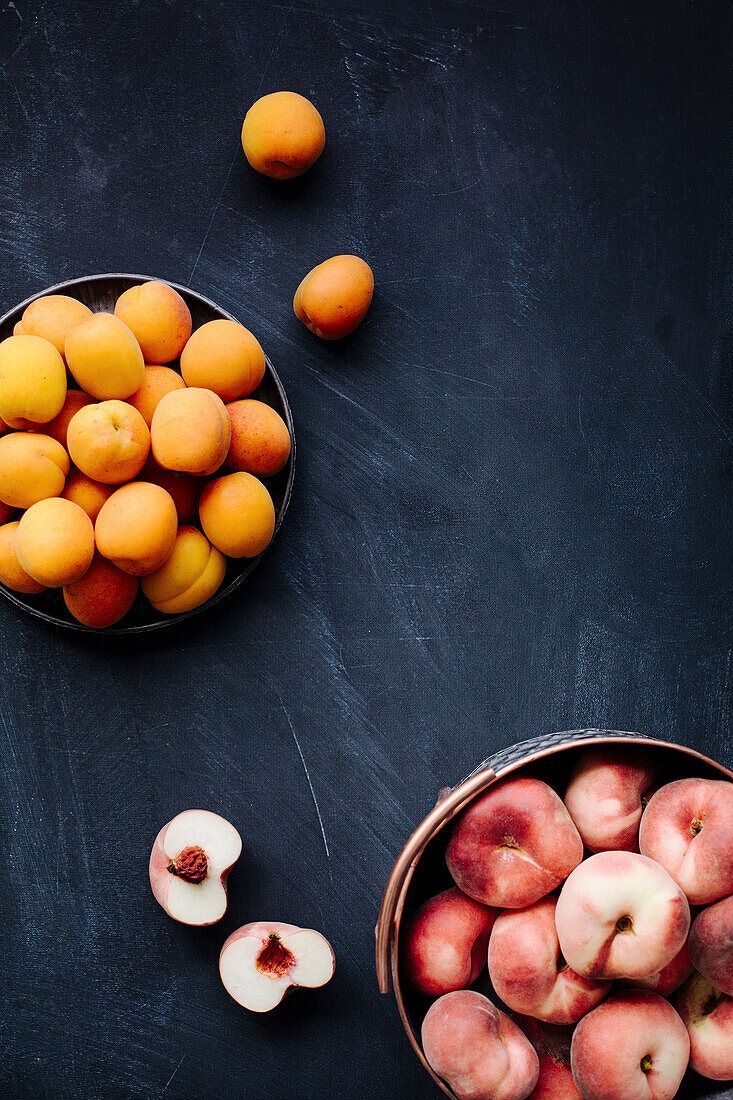 Peaches and apricots on a dark background