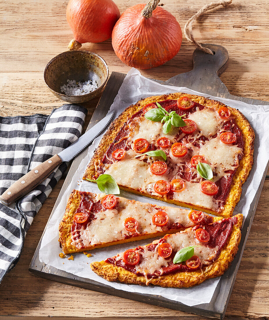 Pumpkin pizza with tomatoes and cheese