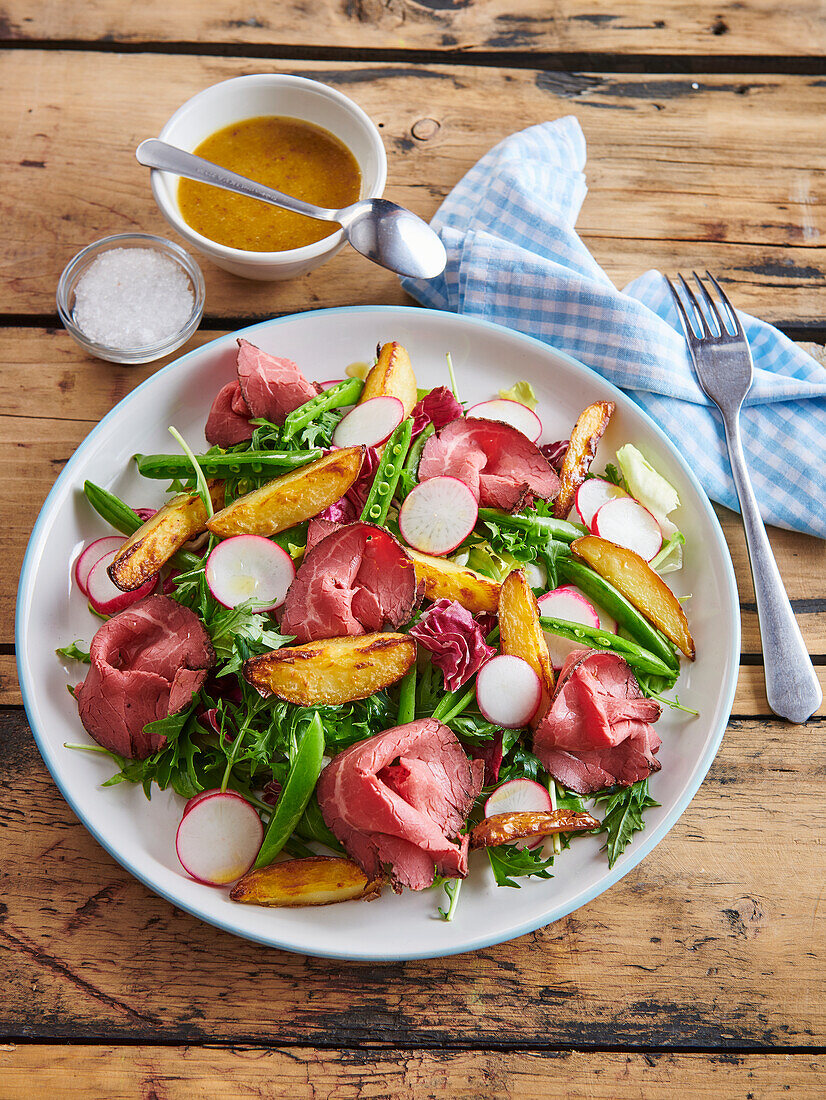 Salad with baked potatoes and roast beef