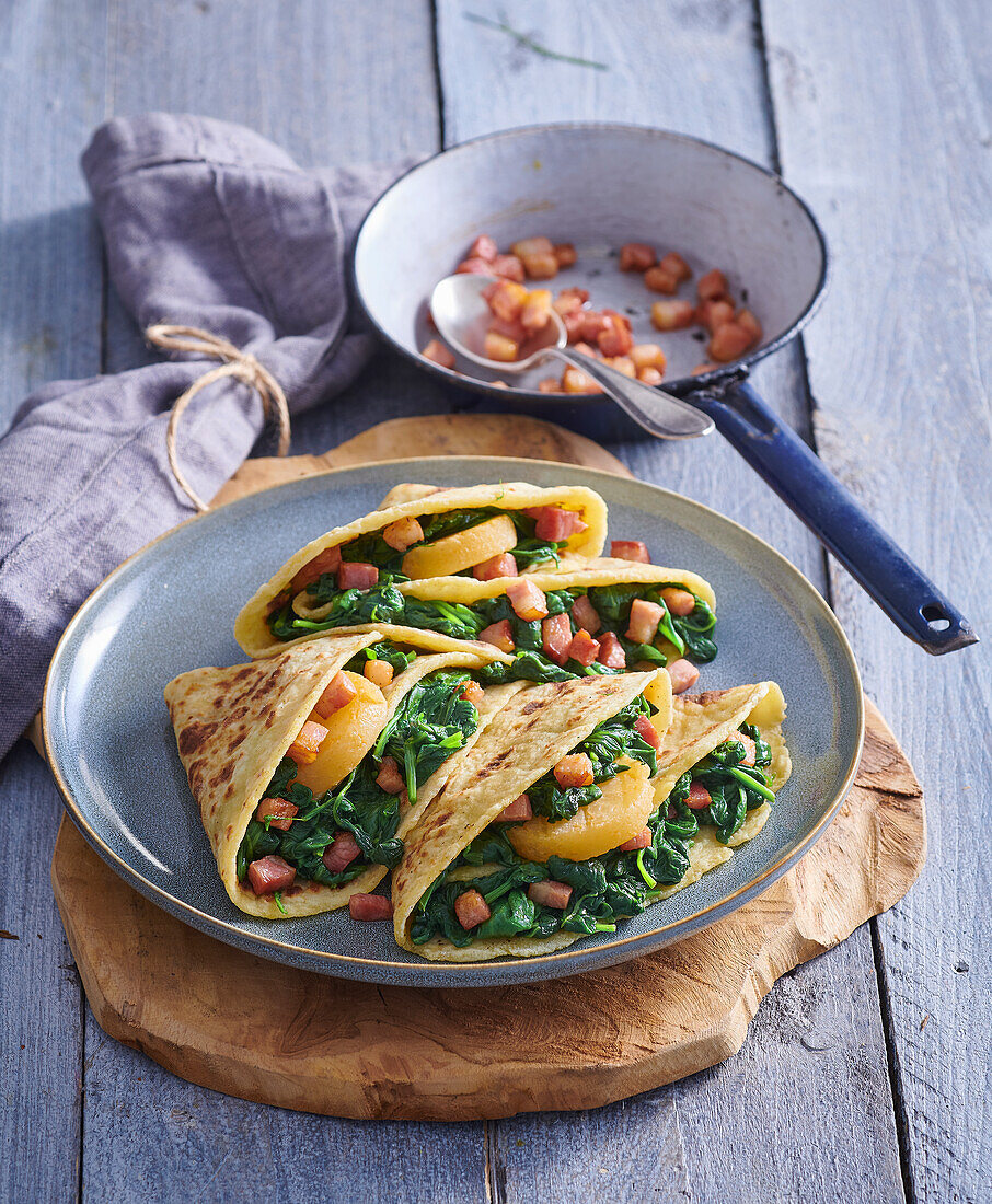 Pancakes with spinach, diced bacon and mature soft cheese
