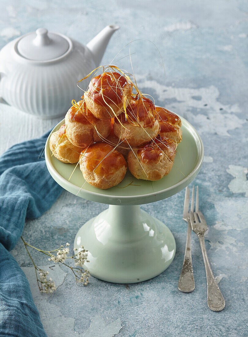 Profiteroles with whipped cream and spun sugar