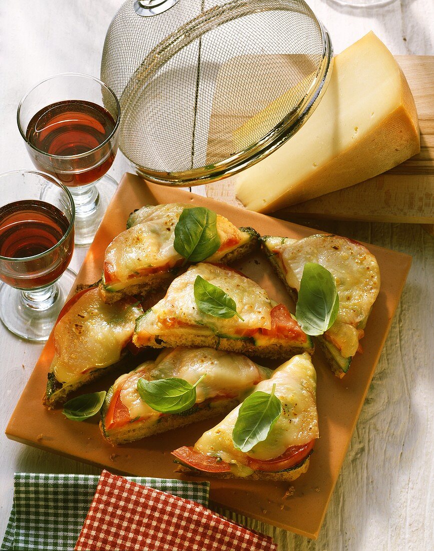 Tomato and courgette cheese toasts, decoration: red wine 