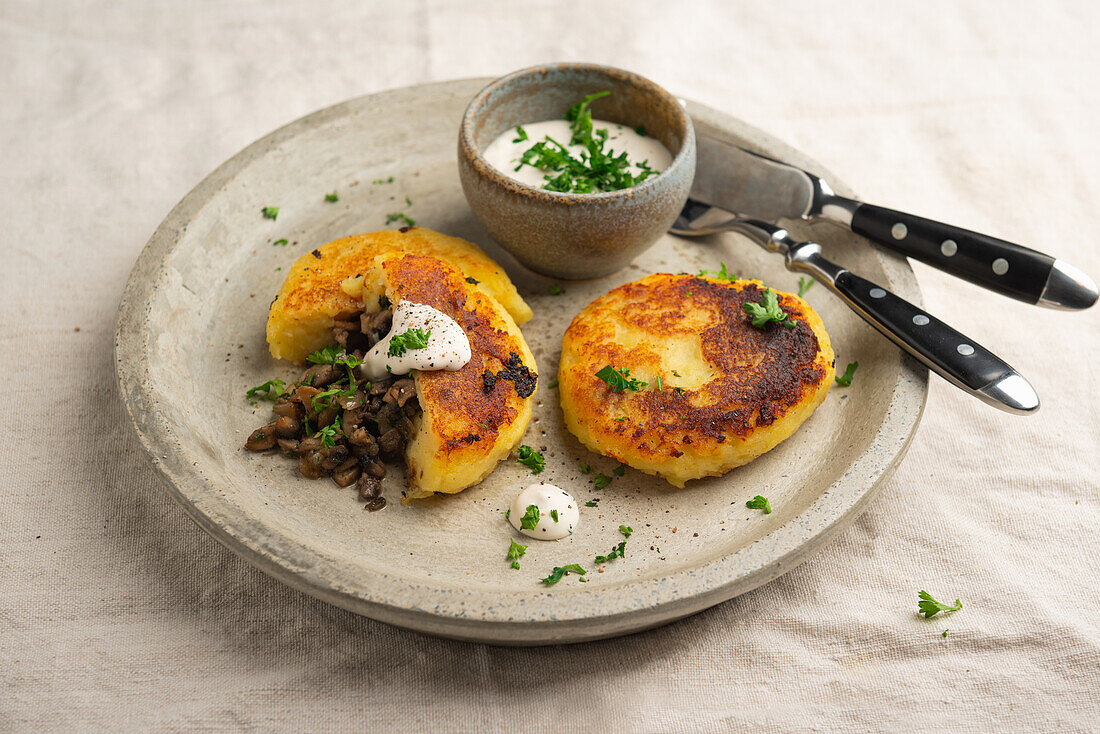 Vegan potato fritters with mushroom filling and herb dip