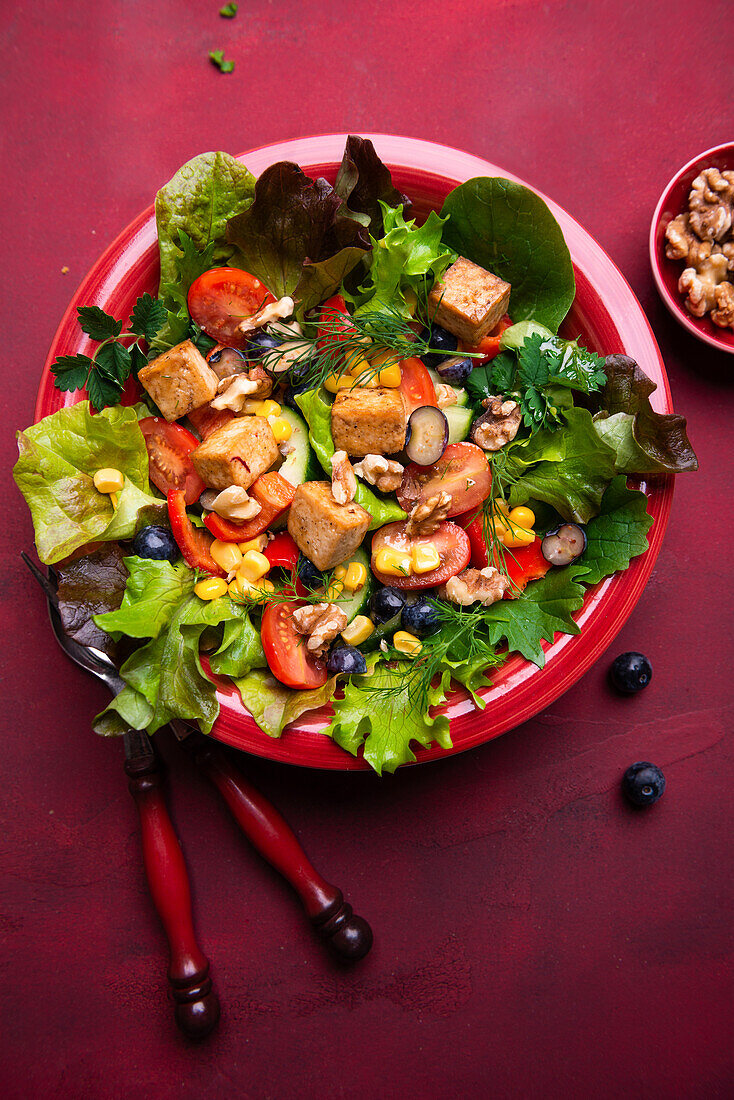 Blattsalate mit Paprika, Mais, Walnüssen, Heidelbeeren und Tofu