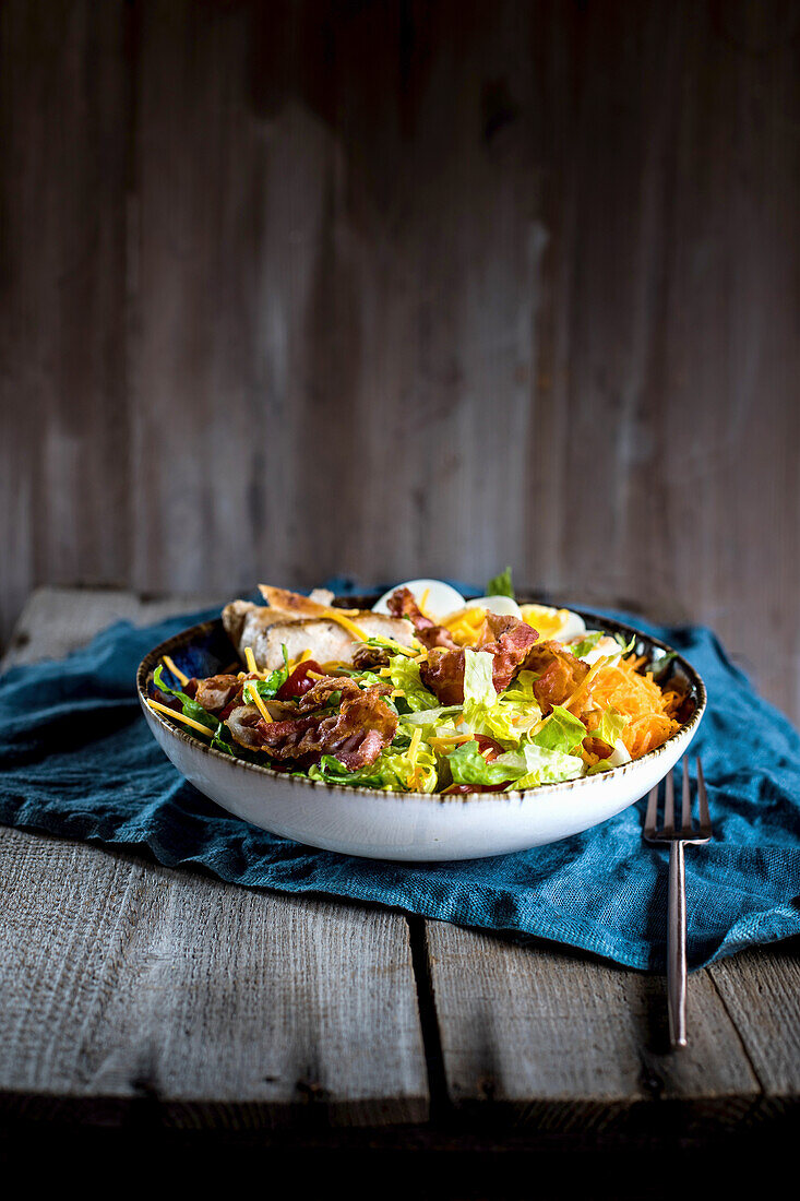 Hearty salad with chicken, bacon, and ranch dressing