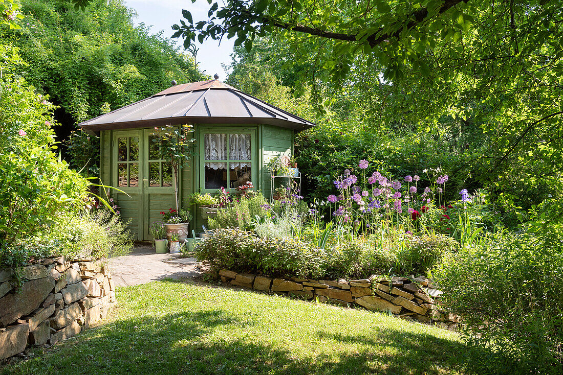 Garden shed and flower bed with a stone border