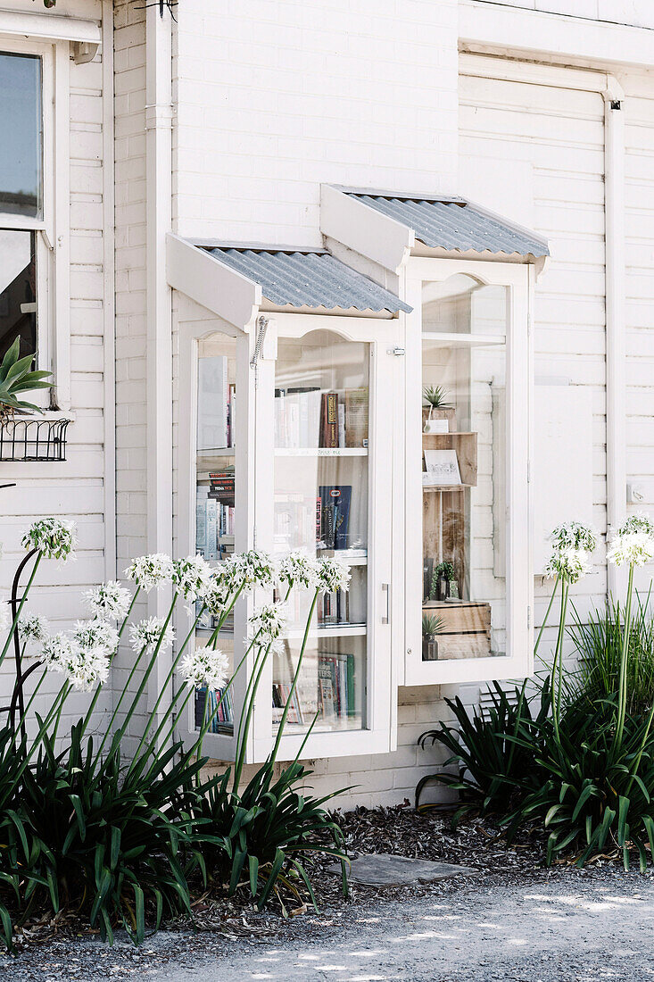 Showcase cabinets on whitewashed wooden house wall