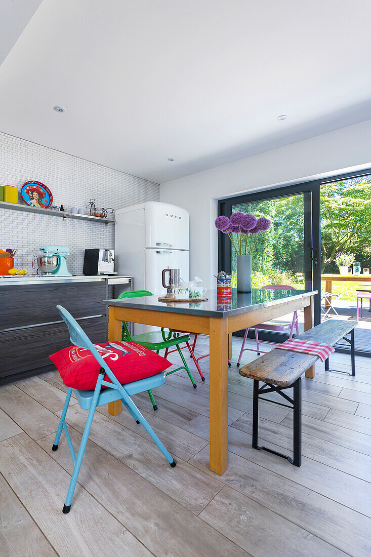 Dining area with various chairs in open kitchen