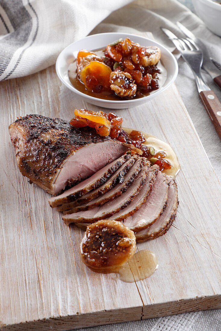 Roasted duck breast served with nuts, dired figs and raisins in honey
