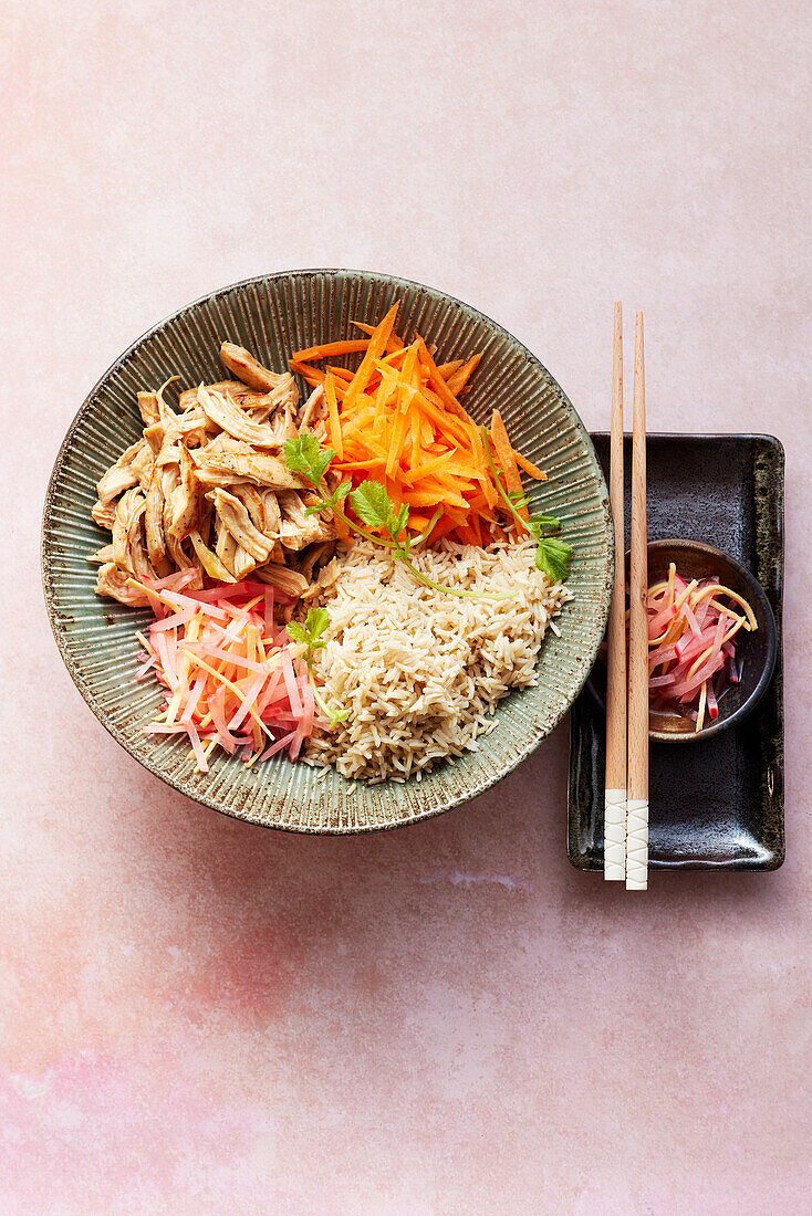 A Japanese donburi bowl with chicken and radishes