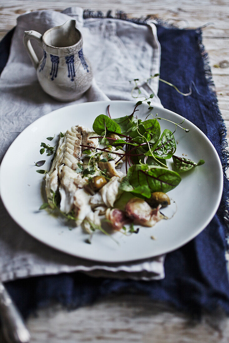 Sea bass baked in salt with lettuce