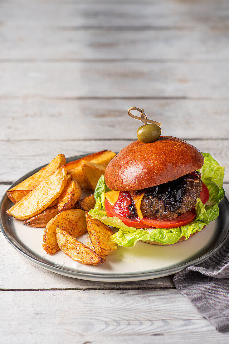beef cheese burger with salad, onion chutney and potato wedges