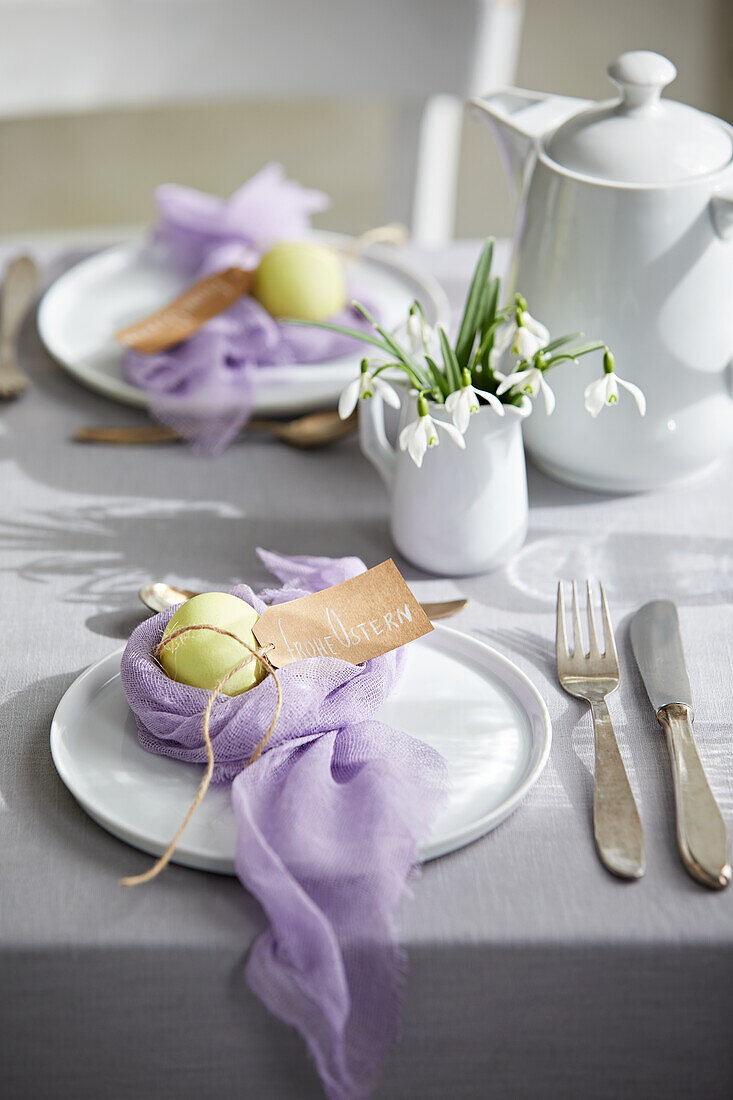 Easter table with colored eggs in a cheesecloth nest