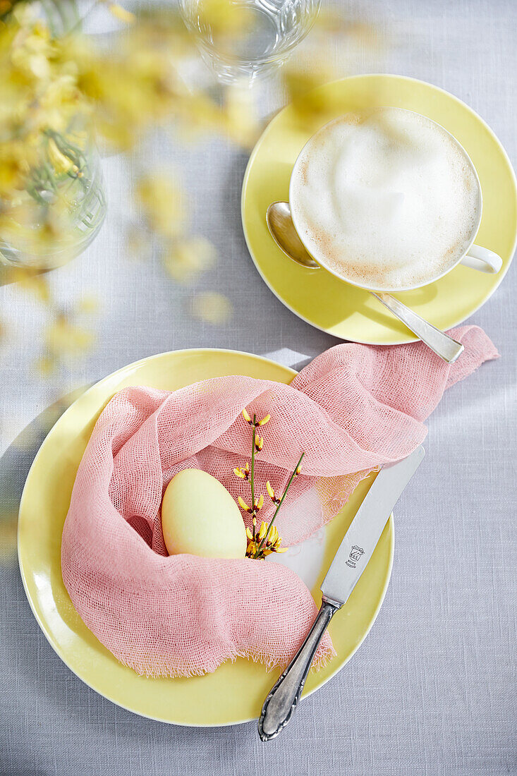 Egg in a muslin cloth nest as Easter table decoration