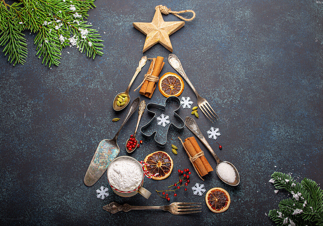 Christmas baking composition made in shape of Christmas fir tree from kitchen tools and cooking ingredients