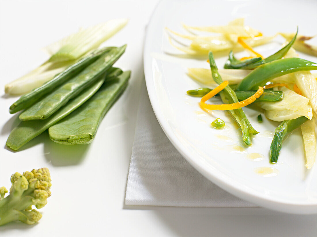 Orange zest with sugar peas and snowpeas