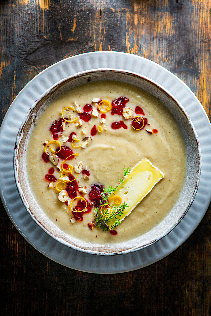 Cream of celery soup with camembert and cranberries