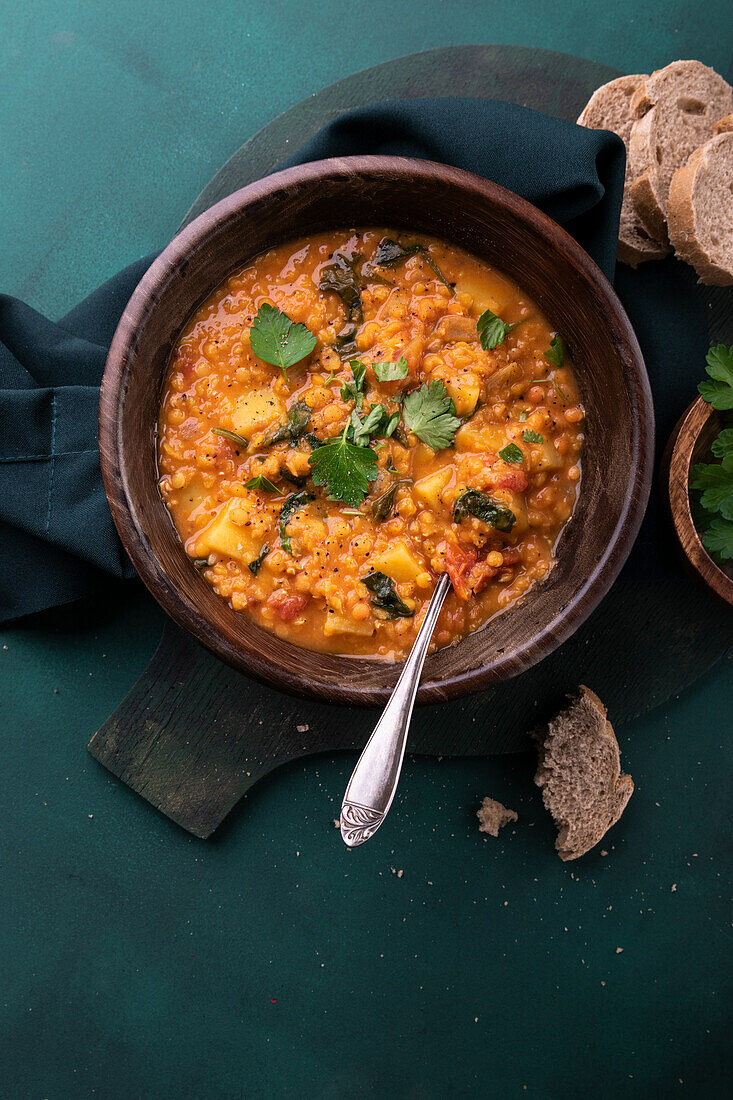 Vegan red lentil stew with potatoes and spinach