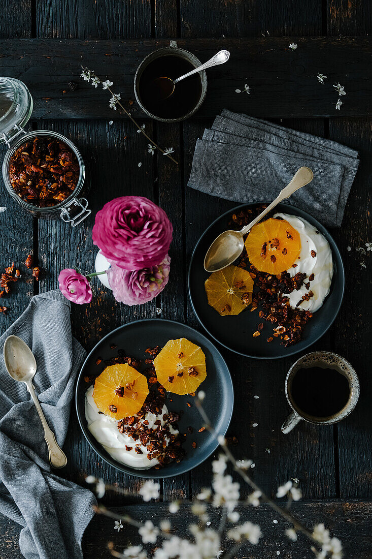 Granola breakfast with yoghurt and oranges