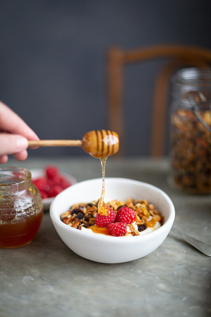 Honey drizzle over yoghurt and granola raspberries