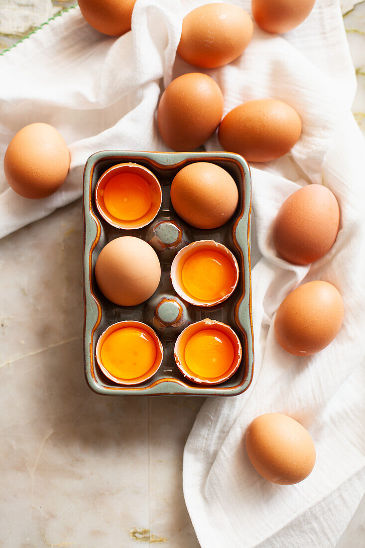 Whole and cracked eggs in an egg container