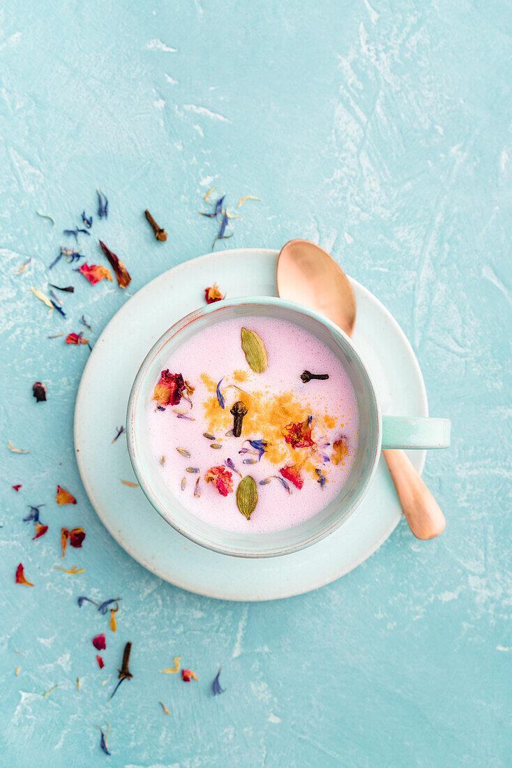 Moon Milk with beet powder, cloves, cardamom, and edible flowers