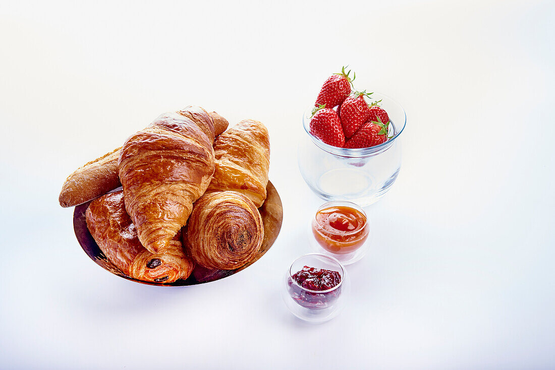 Croissants, pain au chocolat, with jams and strawberries