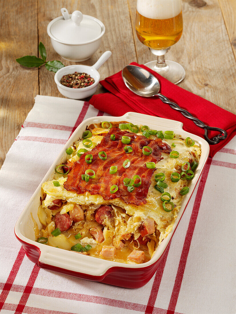 Sauerkraut casserole with pork sausages and smoked meat