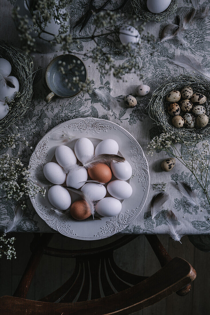 White and brown chicken eggs and quail eggs as Easter decorations