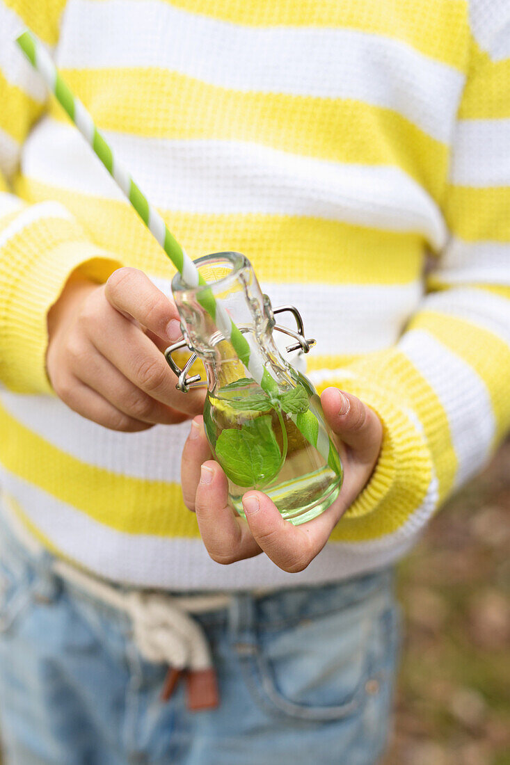 Homemade mint lemonade for a picnic in a small flip-top bottle