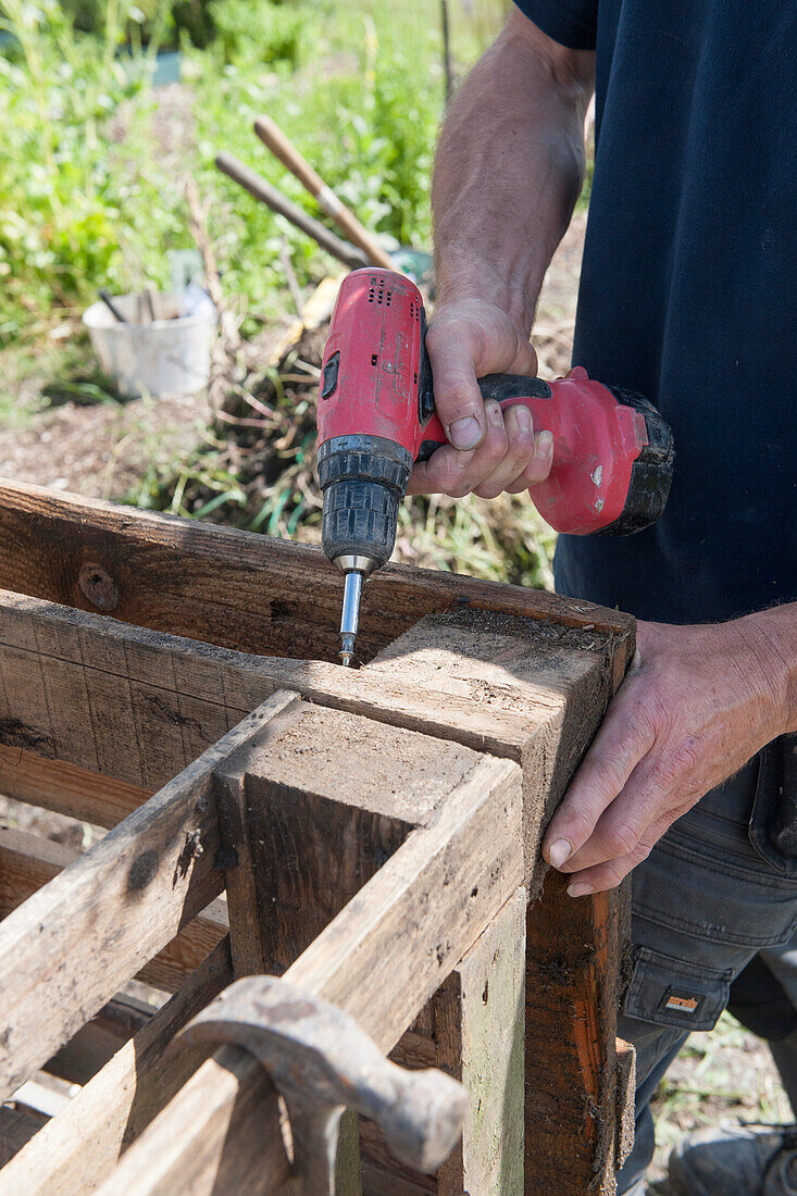 Using drill to construct a compost heap