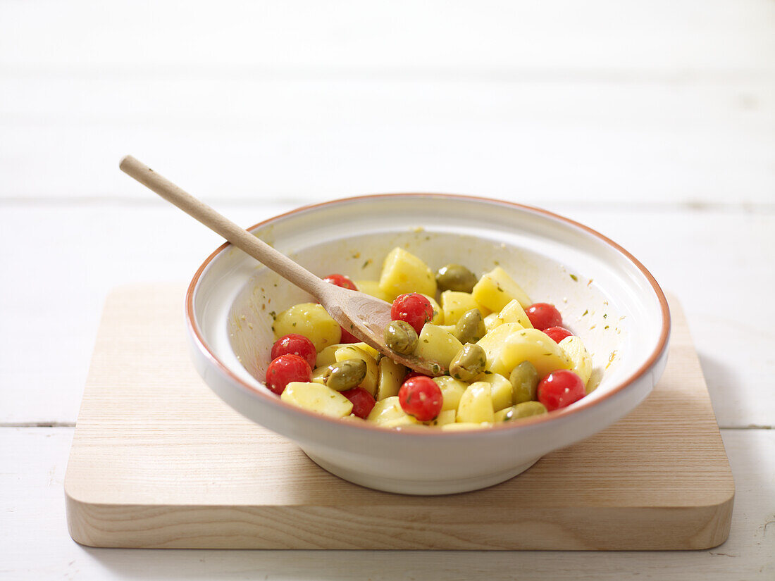 Potatoes, olives and cherry tomatoes in tagine