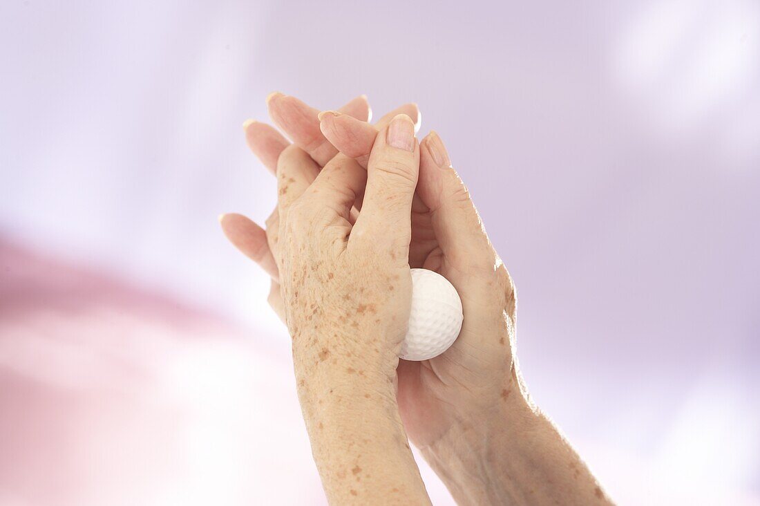 Rolling golf ball in the heel of hand to ease arthritis