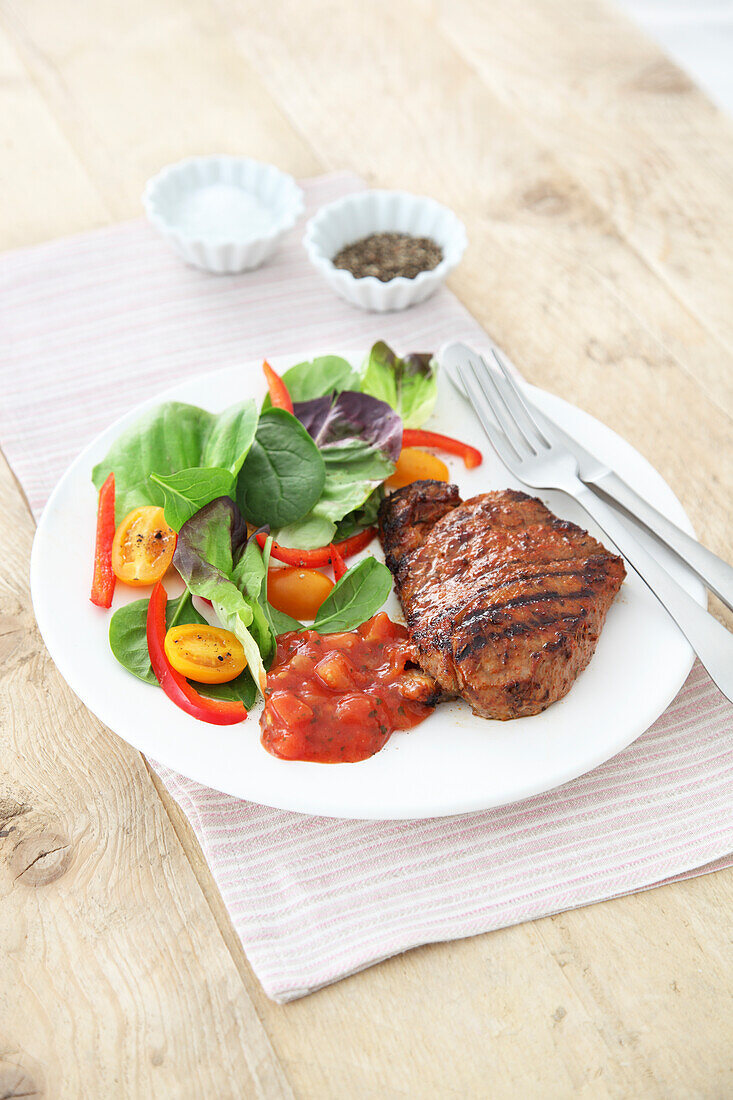 Dry rubbed BBQ steak with salad and salsa