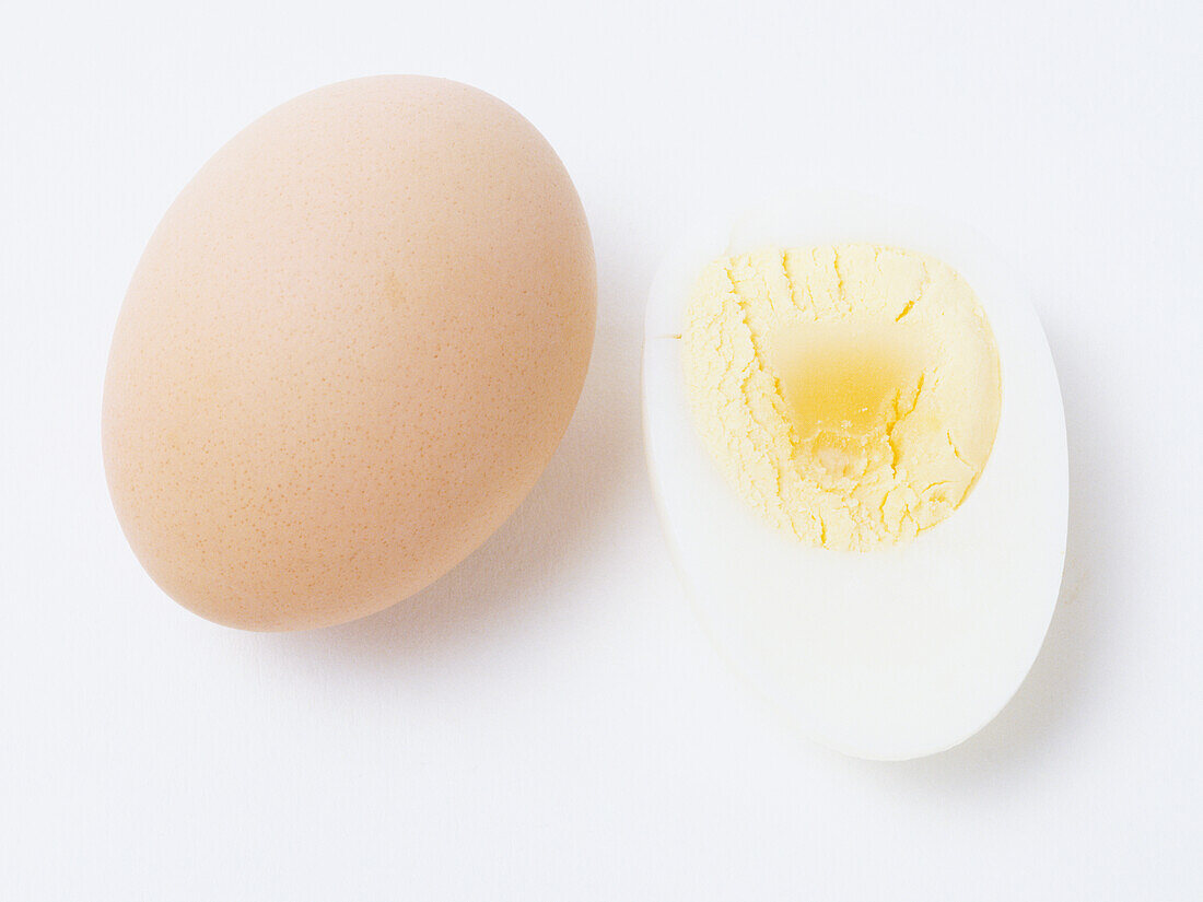 Brown egg and a slice of a boiled egg