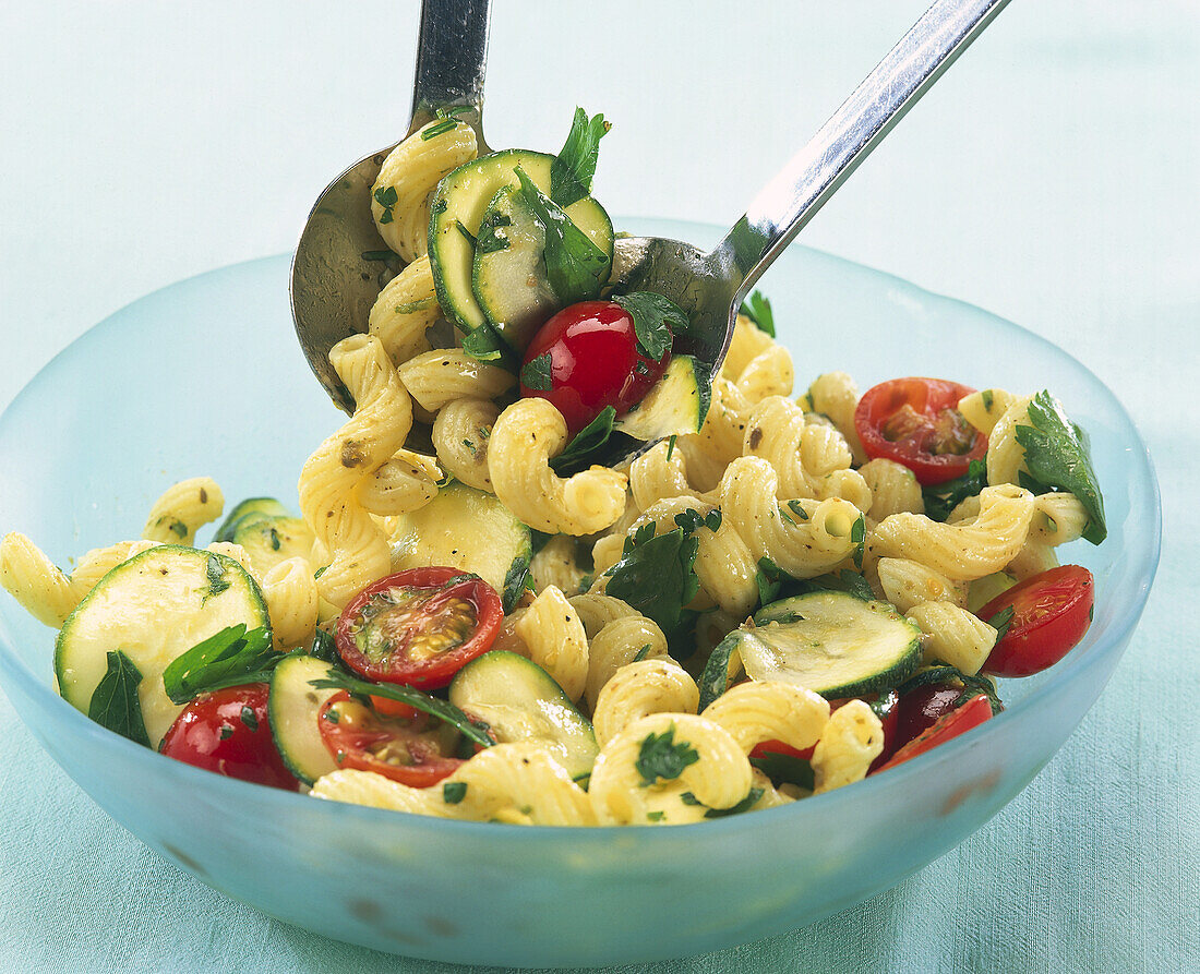 Pasta based dish with dressing and cherry tomatoes