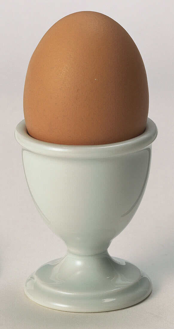 Hard-boiled egg in a white egg cup
