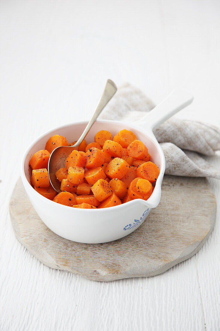 Bowl of glazed carrots and nutmeg