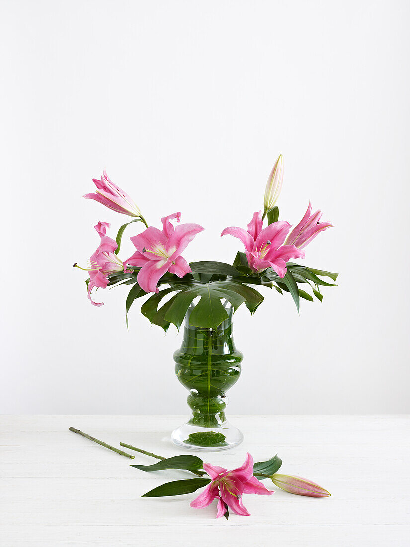 Creating flower arrangement using pink lilies