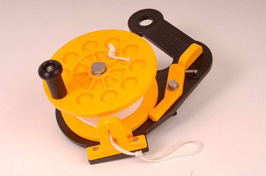 Yellow scuba diving reel with white string