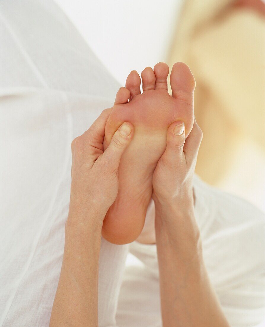Woman massaging foot