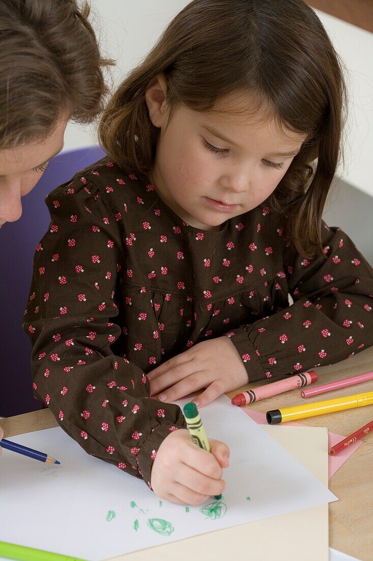 Girl drawing with crayon