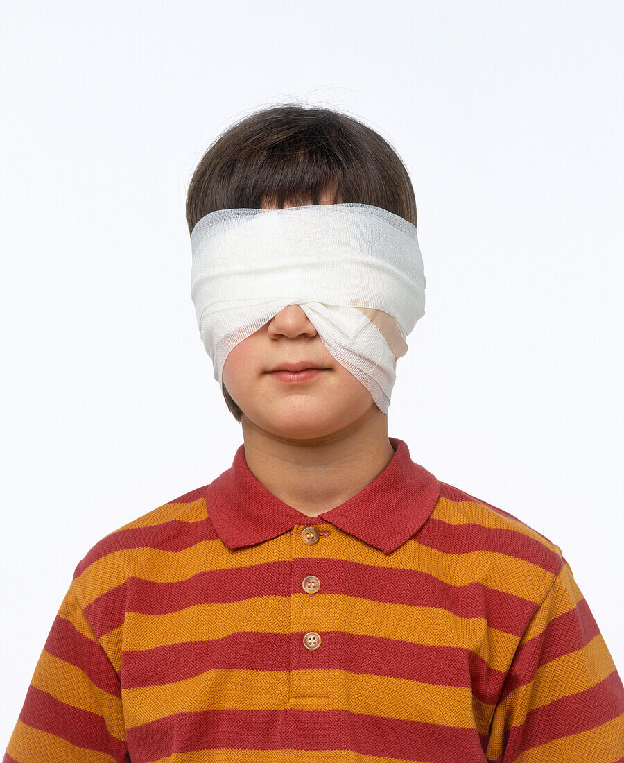 Boy with bandages around eyes