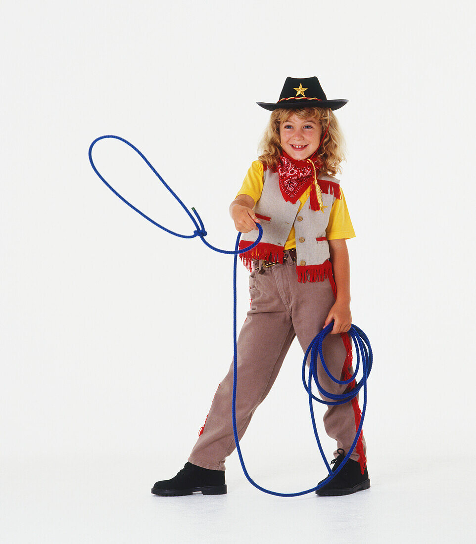 Girl in cowgirl's outfit swinging a lasso