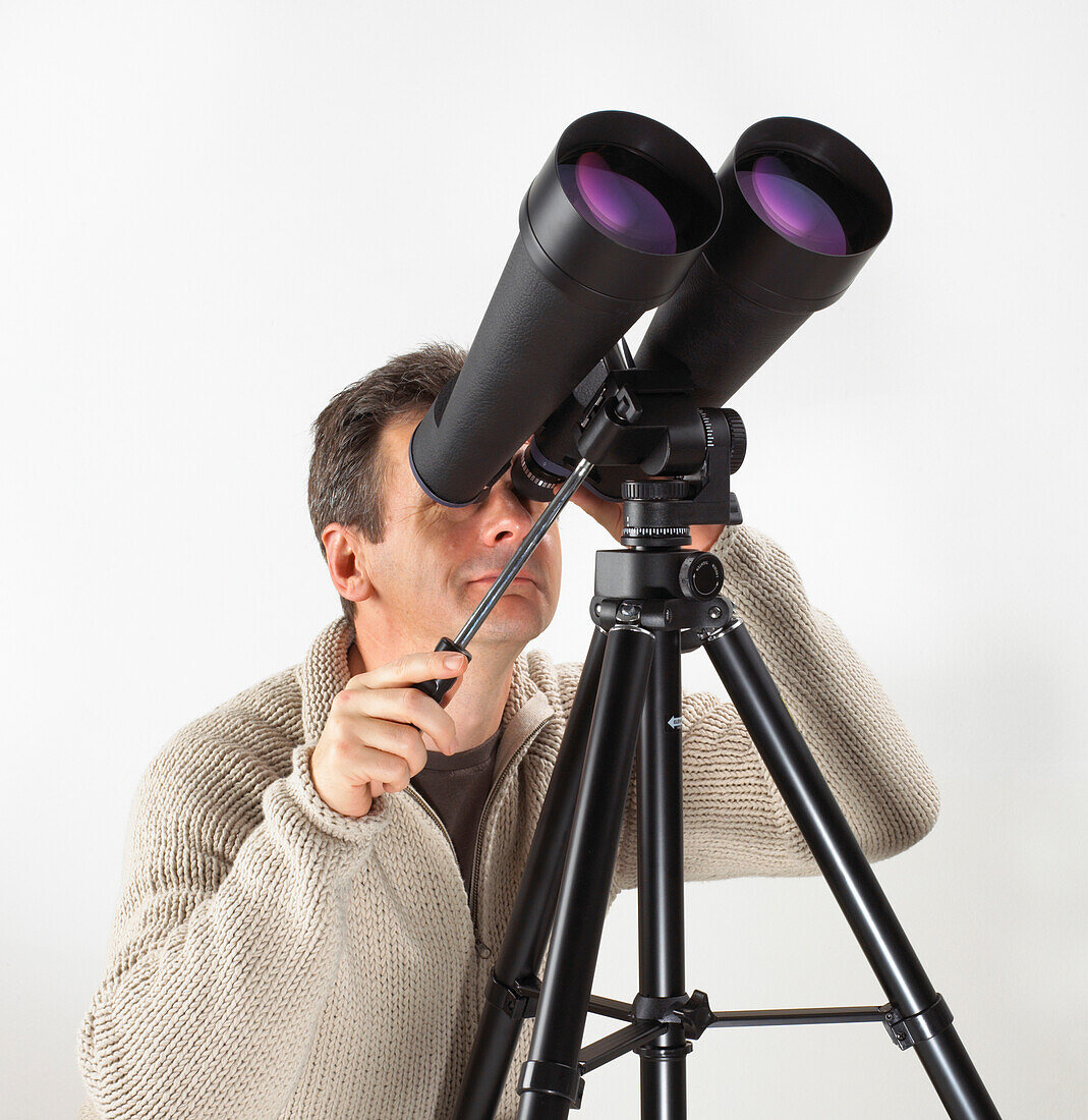 Man looking through binoculars