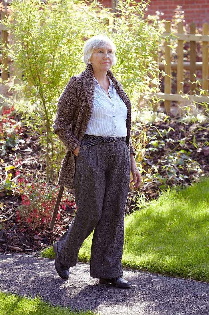 Older woman walking through garden