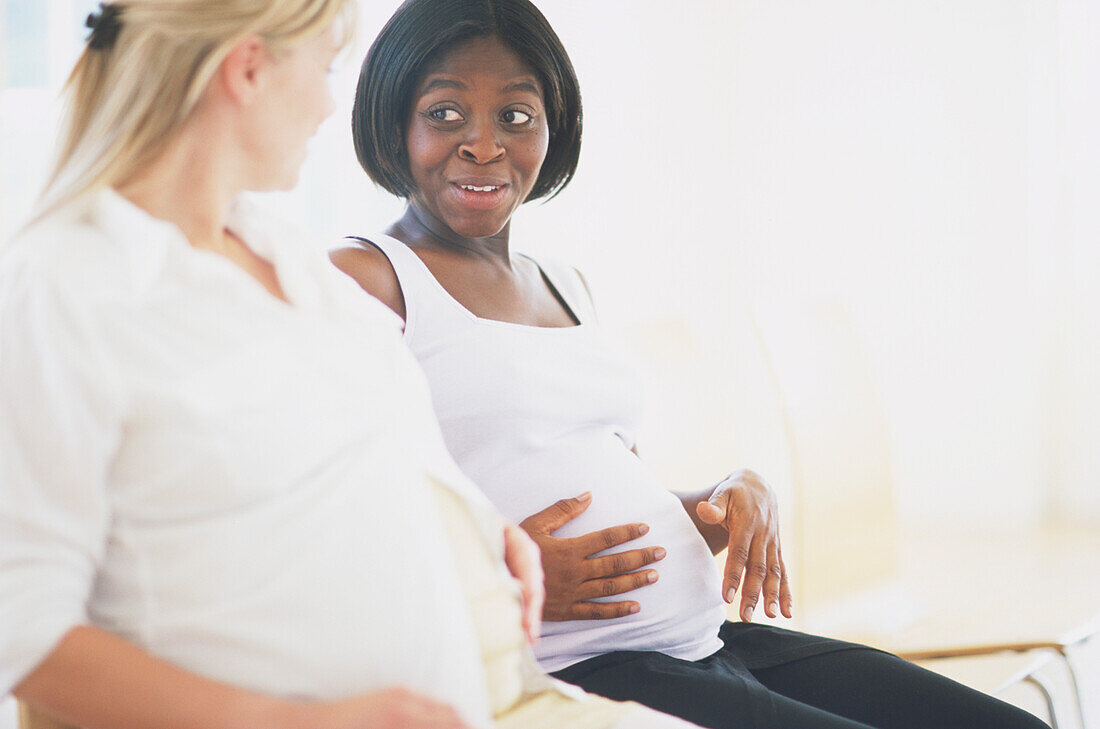 Two pregnant women chatting