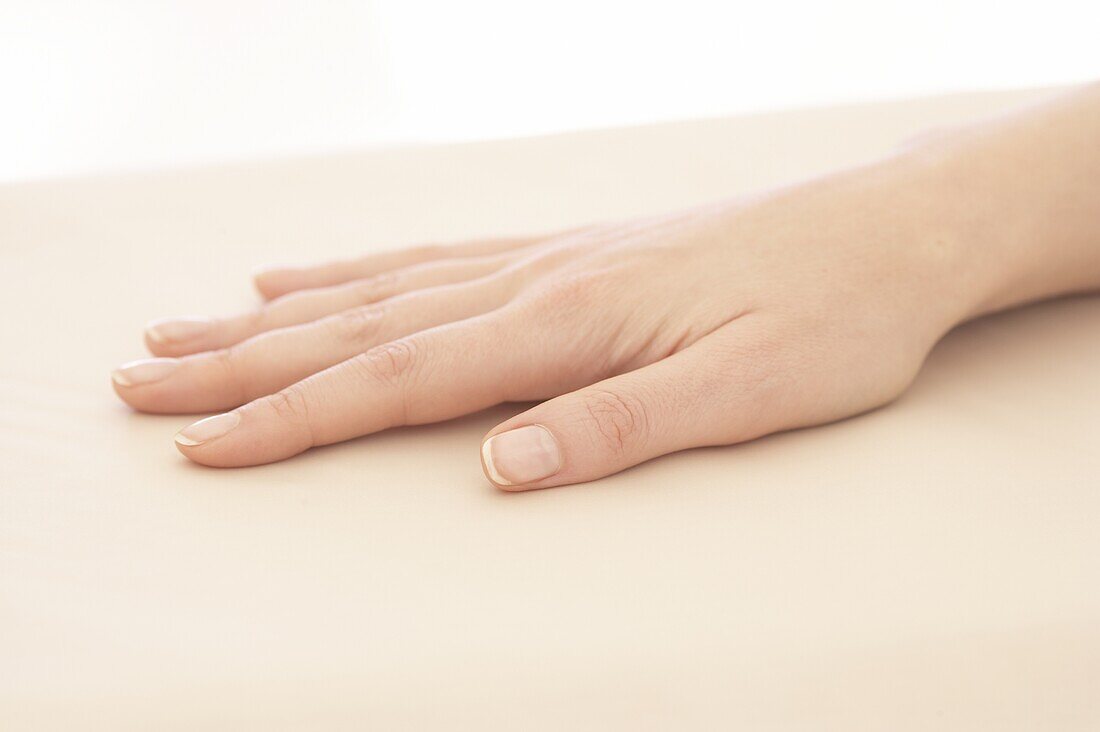 Hand resting on table