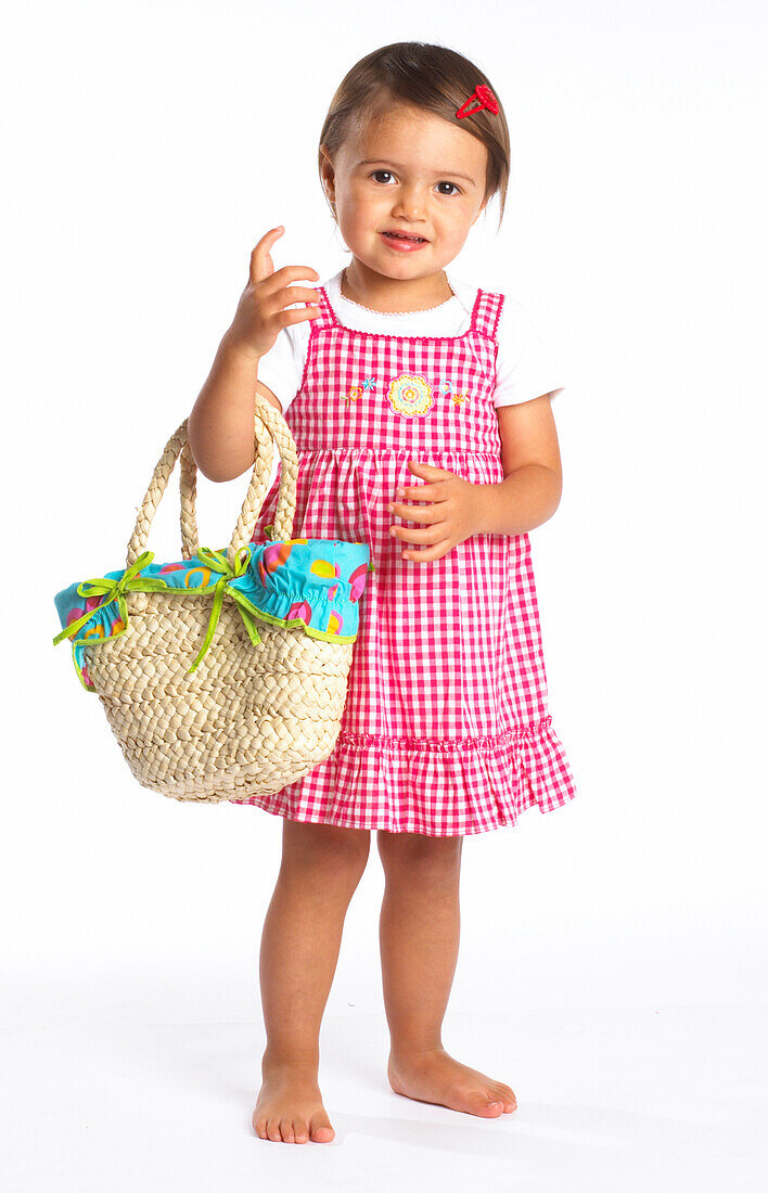 Toddler girl carrying wicker basket