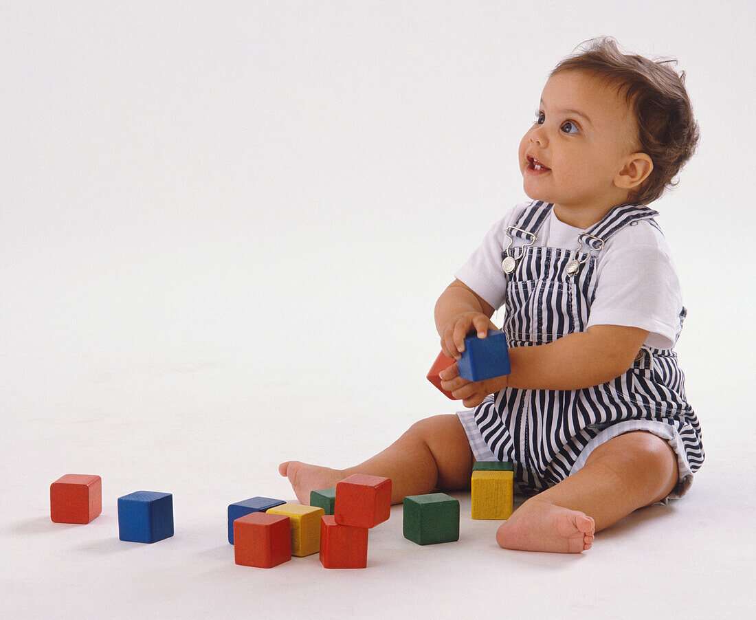 Baby playing with wooden building blocks